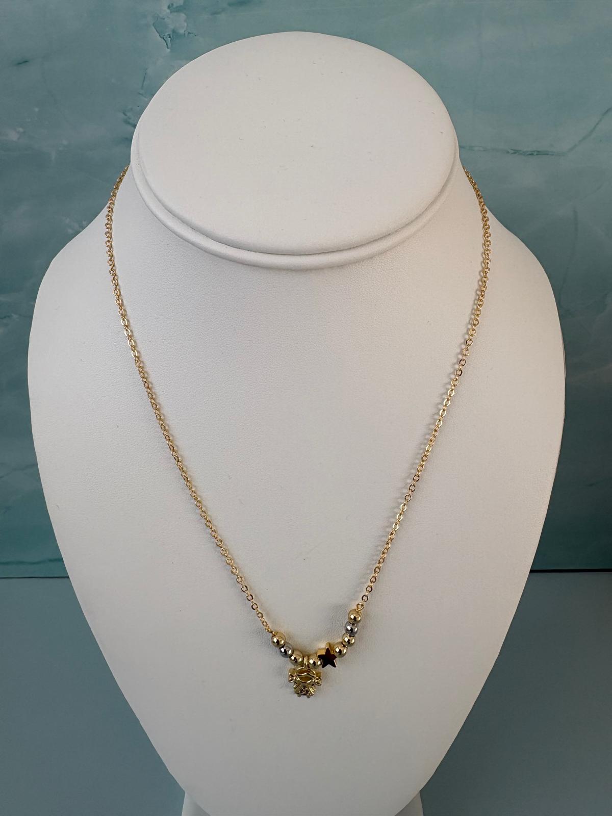 Dainty gold-tone beaded necklace with a little girl charm and star pendant—minimalist, perfect for layering, gifting, and everyday wear
